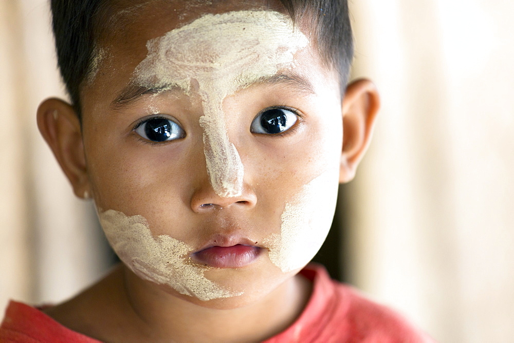 Young Burmese child with Thanakha traditional face painting, Yangon (Rangoon), Myanmar (Burma), Asia