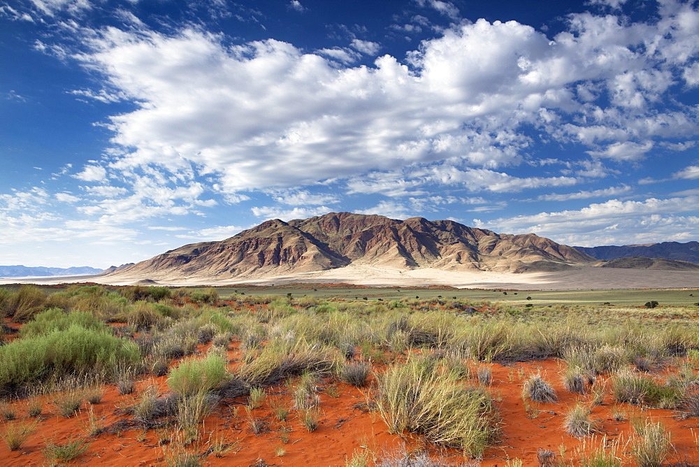 View across magnificent landscape of orange sand dunes and sandstones mountains at Wolwedans, part of the Namib Rand game reserve, Namib Naukluft Park, Namibia, Africa