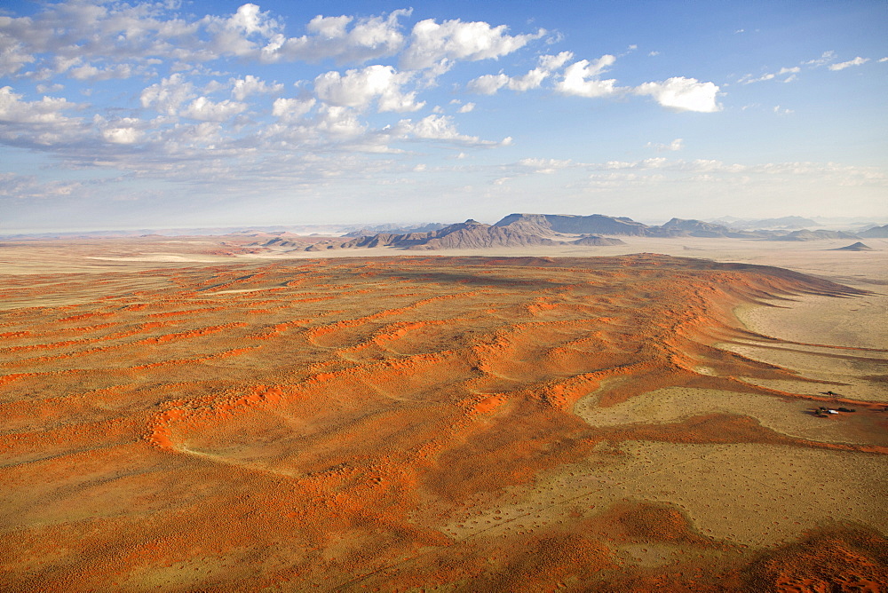 Aerial view from hot air balloon over magnificent desert landscape of sand dunes, mountains and Fairy Circles, Namib Rand game reserve Namib Naukluft Park, Namibia, Africa