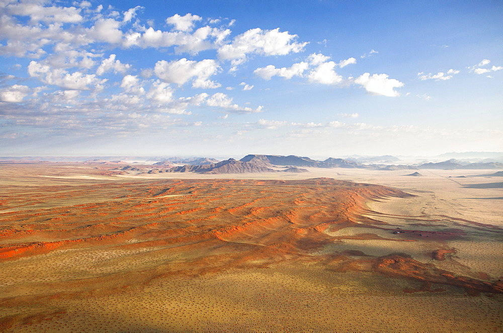 Aerial view from hot air balloon over magnificent desert landscape of sand dunes, mountains and Fairy Circles, Namib Rand game reserve Namib Naukluft Park, Namibia, Africa