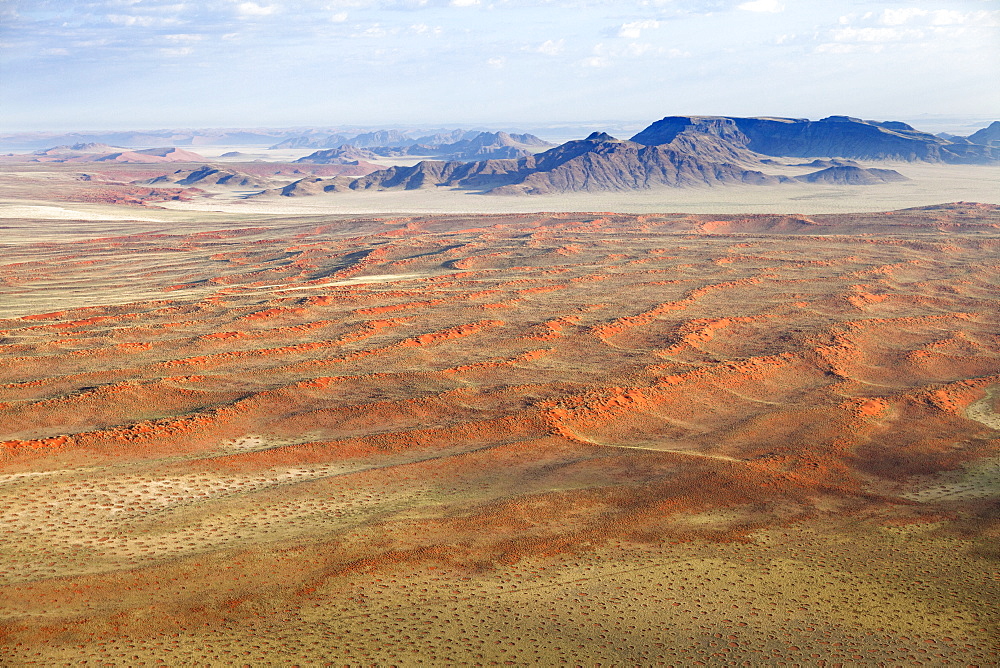 Aerial view from hot air balloon over magnificent desert landscape of sand dunes, mountains and Fairy Circles, Namib Rand game reserve Namib Naukluft Park, Namibia, Africa