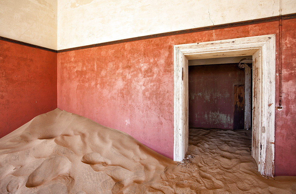 Interior of building slowly being consumed by the sands of the Namib Desert in the abandoned former German diamond mining town of Kolmanskop, Forbidden Diamond Area near Luderitz, Namibia, Africa 