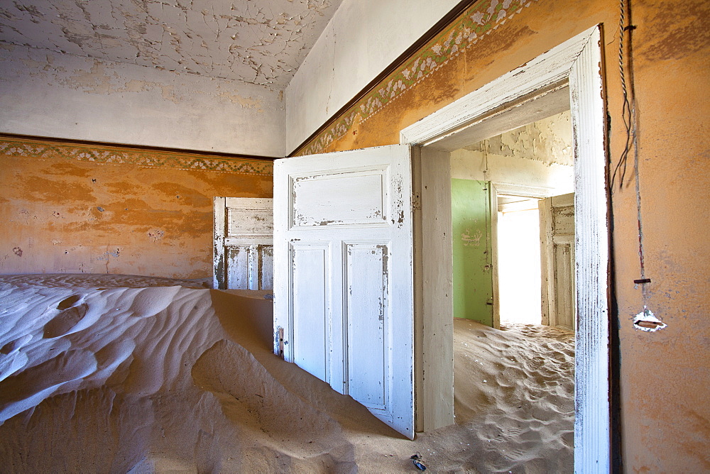 Interior of building slowly being consumed by the sands of the Namib Desert in the abandoned former German diamond mining town of Kolmanskop, Forbidden Diamond Area near Luderitz, Namibia, Africa