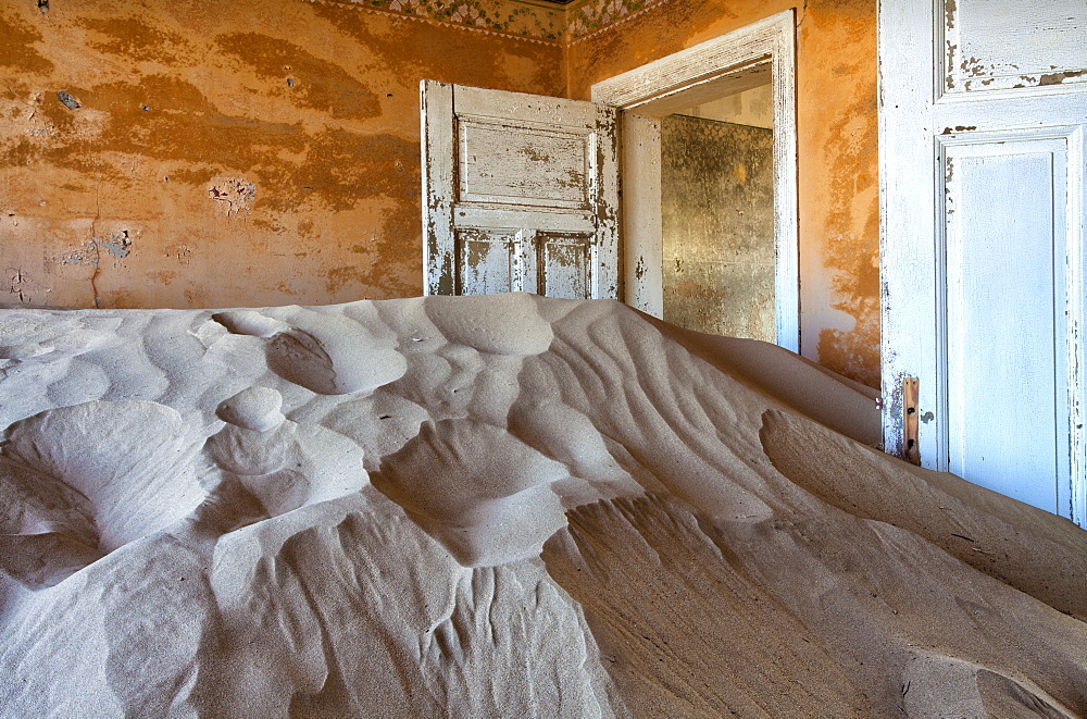 Interior of building slowly being consumed by the sands of the Namib Desert in the abandoned former German diamond mining town of Kolmanskop, Forbidden Diamond Area near Luderitz, Namibia, Africa