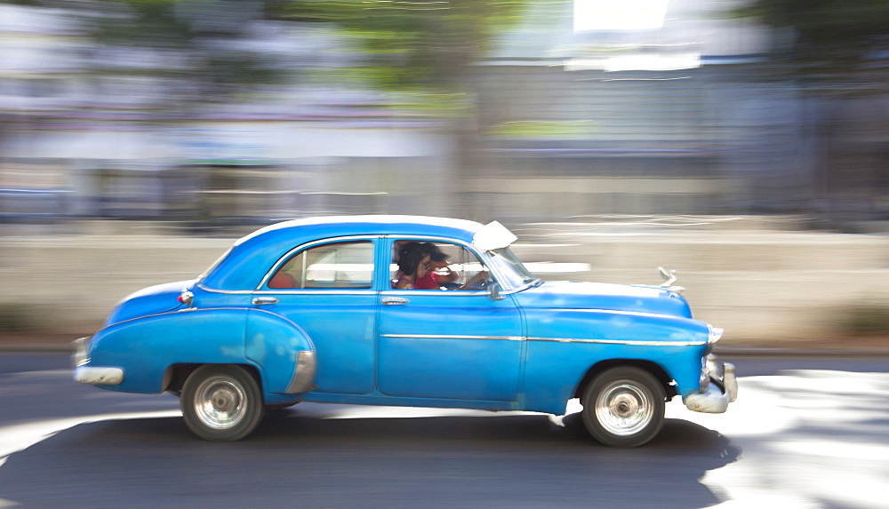 Panned' shot of old American car to capture sense of movement, Prado, Havana Centro, Cuba, West Indies, Central America