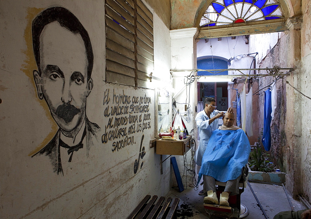 Man having haircut in backstreet barber shop, Havana Viejo, Havana, Cuba, West Indies, Central America 