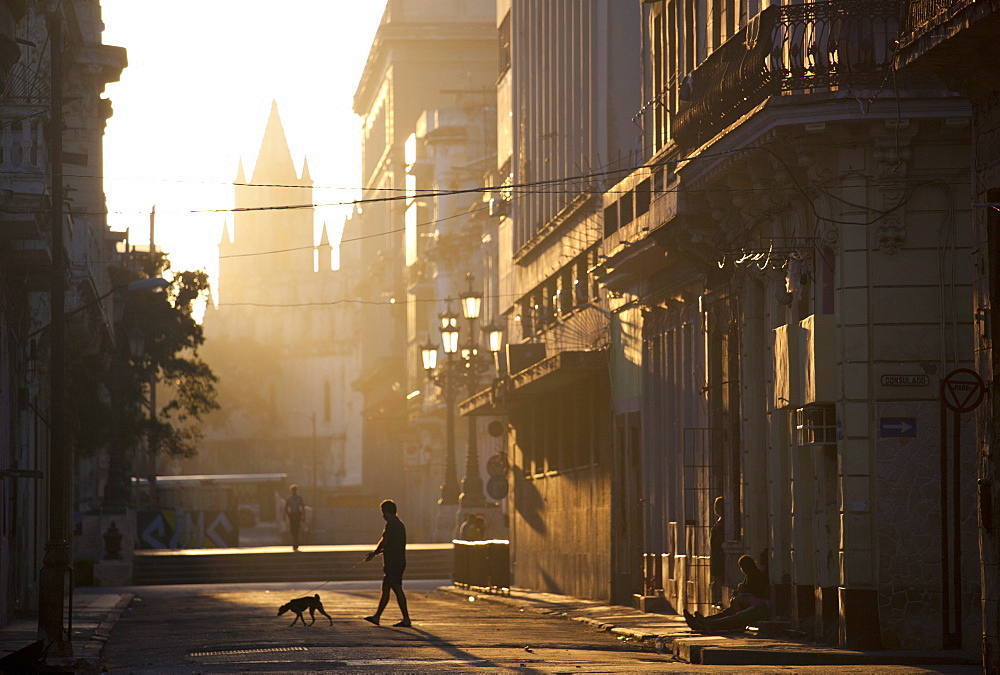 Backlit street at dawn with people in semi-silhouette, off Prado, Havana Centro, Havana, Cuba, West Indies, Central America 