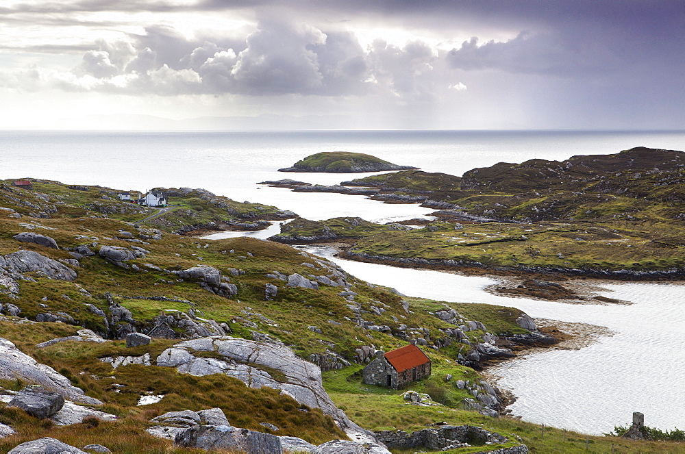 View out to sea over abandoned crofts at the township of Manish on the east coast of the Isle of Harris, Outer Hebrides, Scotland, United Kingdom, Europe 