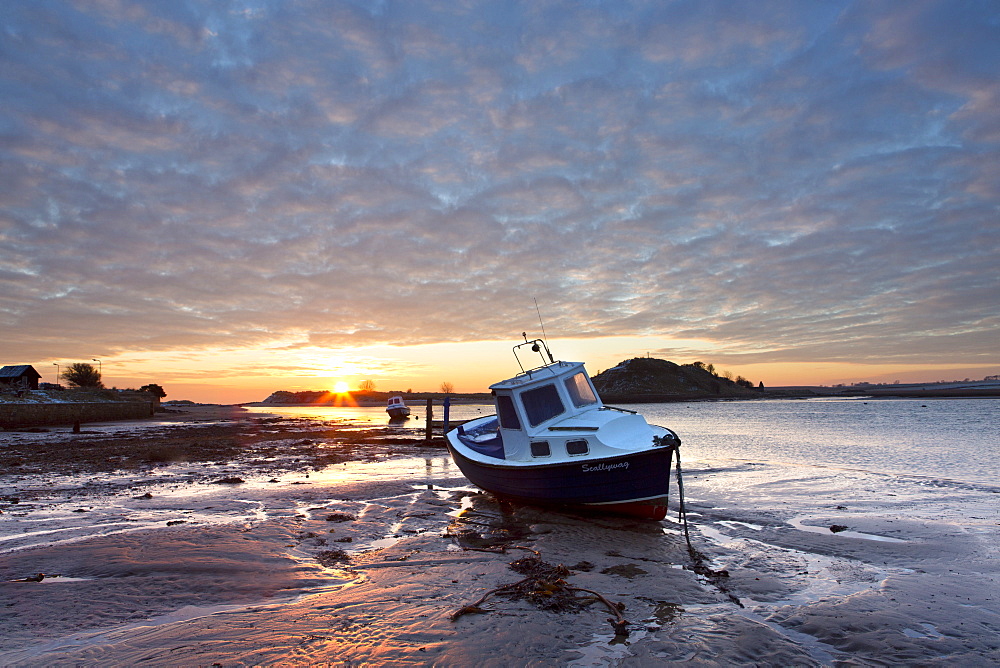 Winter sunrise on the Aln Estuary looking across the sand at low tide to Church Hill, Alnmouth, near Alnwick, Northumberland, England, United Kingdom, Europe