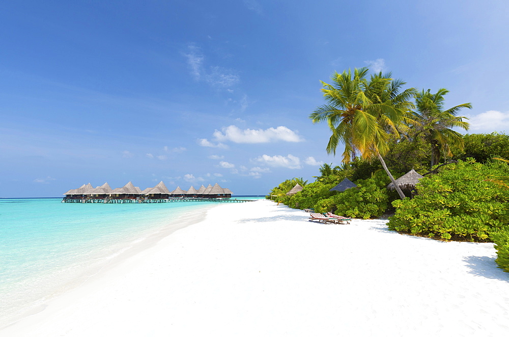 View along tropical beach towards over-water villas, Coco Palm Resort, Dhuni Kolhu, Baa Atoll, Republic of Maldives, Indian Ocean, Asia