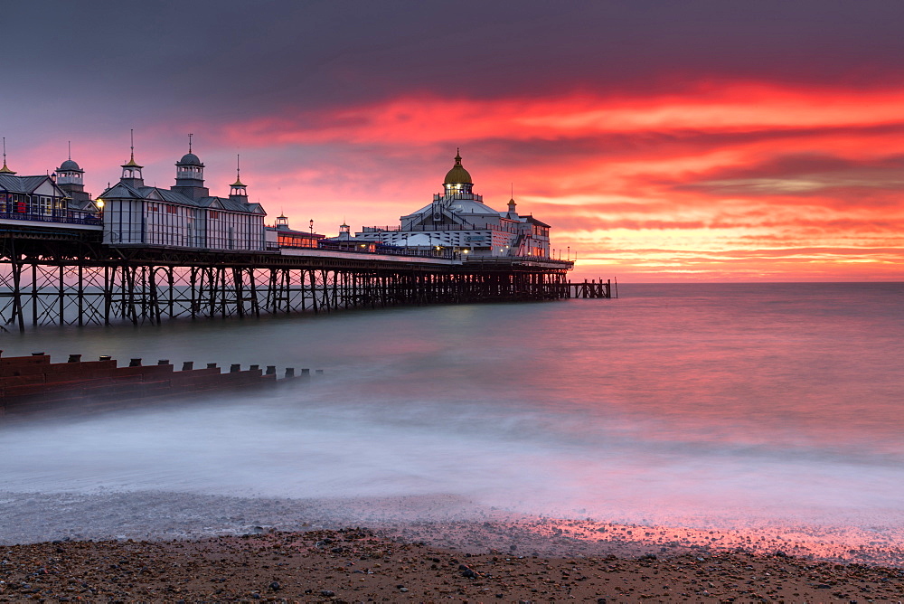 Eastbourne Pier against fiery red sky at sunrise, Eastbourne, East Sussex, England, United Kingdom, Europe