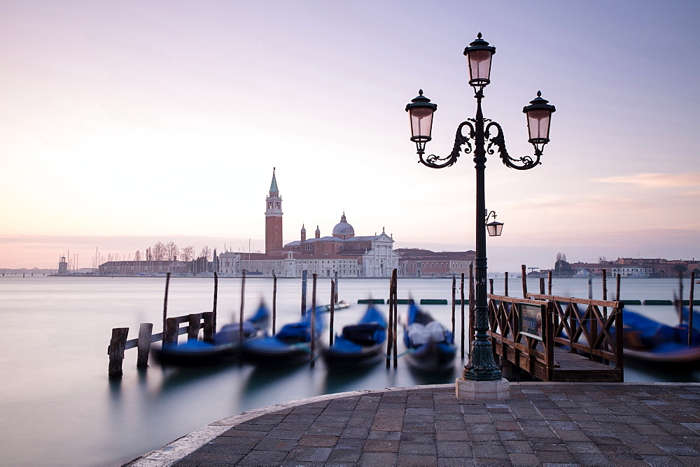 View towards San Giorgio Maggiore at dawn from Riva Degli Schiavoni, with gondolas in foreground, Venice, UNESCO World Heritage Site, Veneto, Italy, Europe