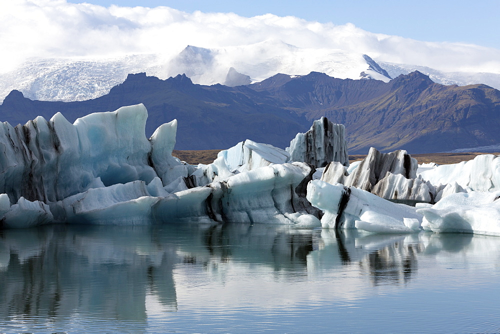 Icebergs on Jokulsarlon Glacial Lagoon, with mountains and glaciers in the background, South Iceland, Polar Regions