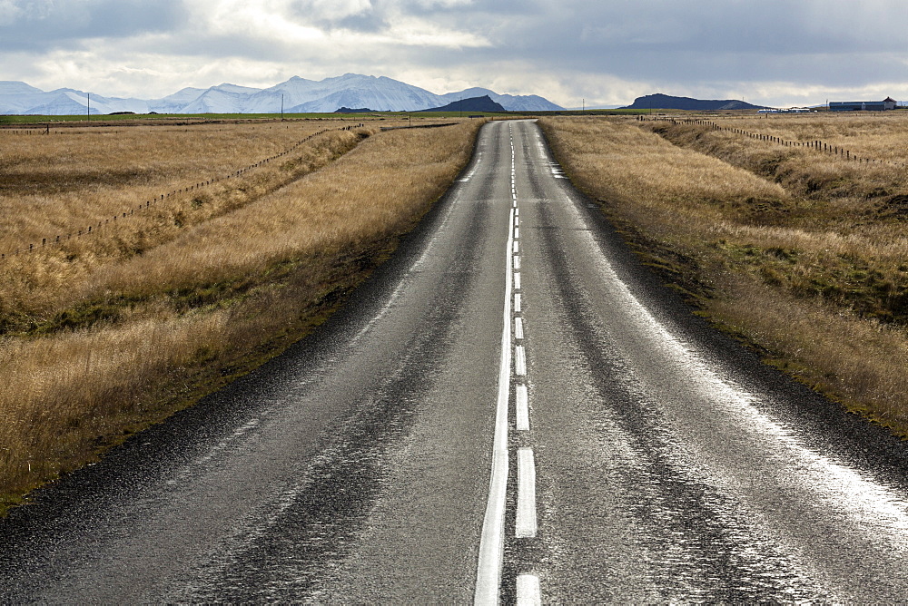 Road stretching away towards distant mountains, Snaefellsnes Peninsula, Iceland, Polar Regions