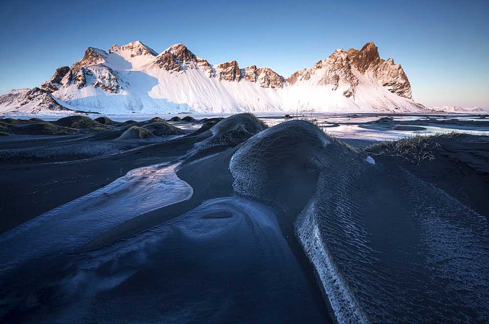 Frozen winter landscape at dusk with Vestrahorn mountains in distance, Stokksnes, South Iceland, Polar Regions