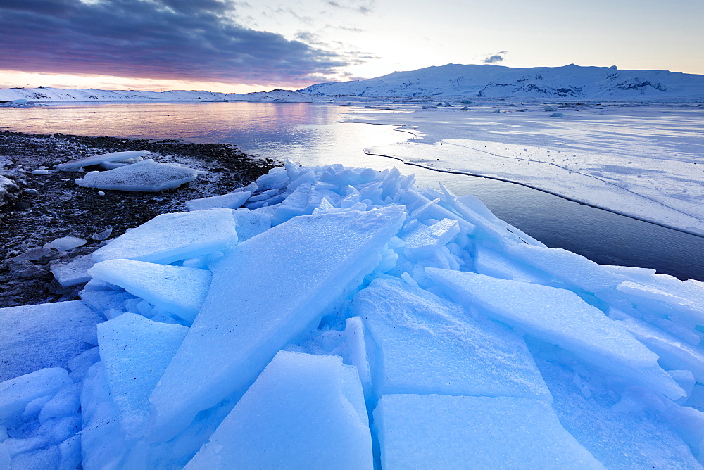 Sunset over frozen Jokulsarlon Glacial Lagoon in winter, South Iceland, Polar Regions