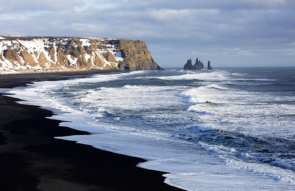 Winter view across the North Atlantic from Dyrholaey towards Reynisdrangar, near Vik, South Iceland, Polar Regions