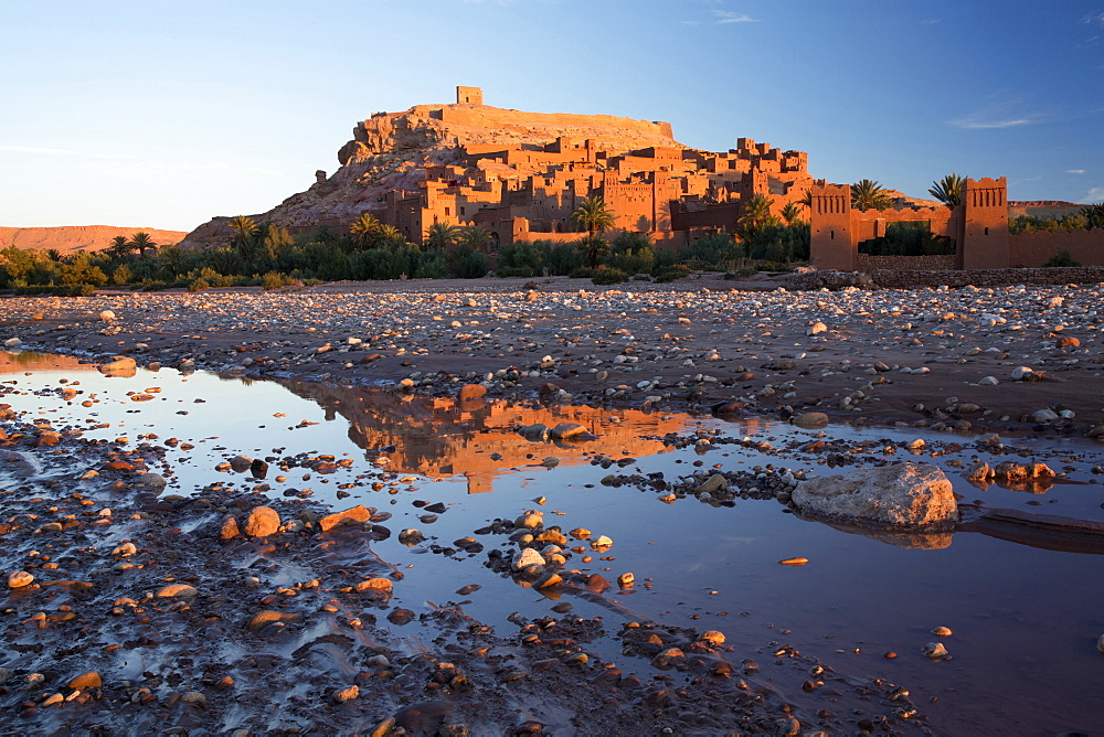 The ancient Kasbah Ait Benhaddou bathed in morning light and reflecting in river, UNESCO World Heritage Site, near Ouarzazate, Morocco, North Africa, Africa