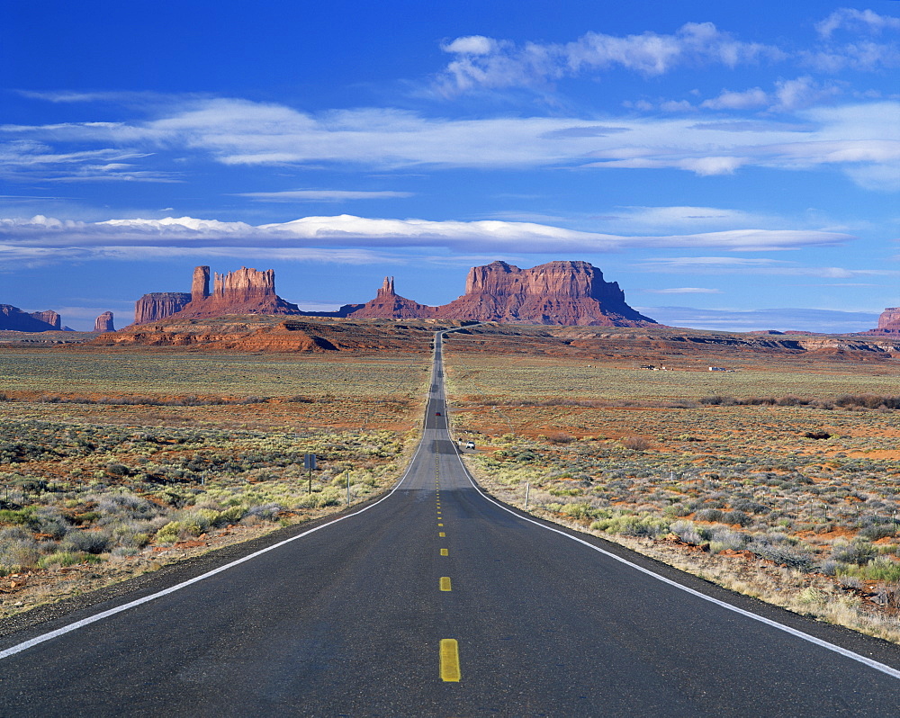 Straight road heading for Monument Valley, Navajo Reserve, on border of Arizona and Utah, United States of America, North America