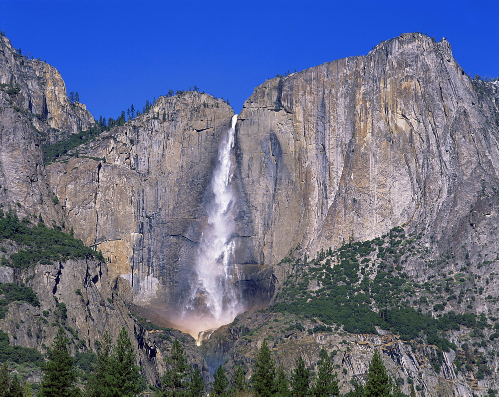 Waterfall cascades over rock wall at Rainbow Falls in the Yosemite Park, UNESCO World Heritage Site, California, United States of America, North America