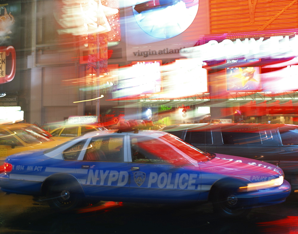 NYPD police car speeding through Times Square, New York City, New York, United States of America, North America