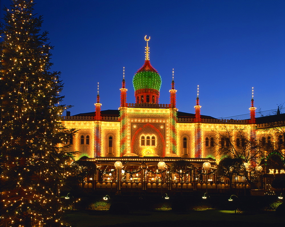 Illuminated Christmas tree and the Pavilion at dusk, Tivoli Gardens, Copenhagen, Denmark, Scandinavia, Europe