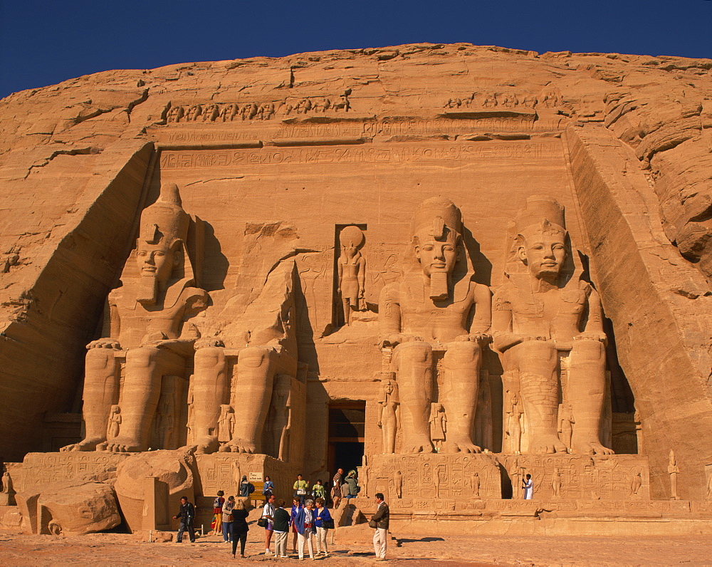 Tourists in front of the Temple of Re-Herakhte, built for Ramses II, also known as the Sun or Great Temple of Ramses II, Abu Simbel, UNESCO World Heritage Site, Nubia, Egypt, North Africa, Africa