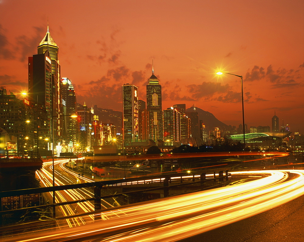 Lights on skyscrapers and traffic trails in the financial district of Hong Kong at sunset, China, Asia