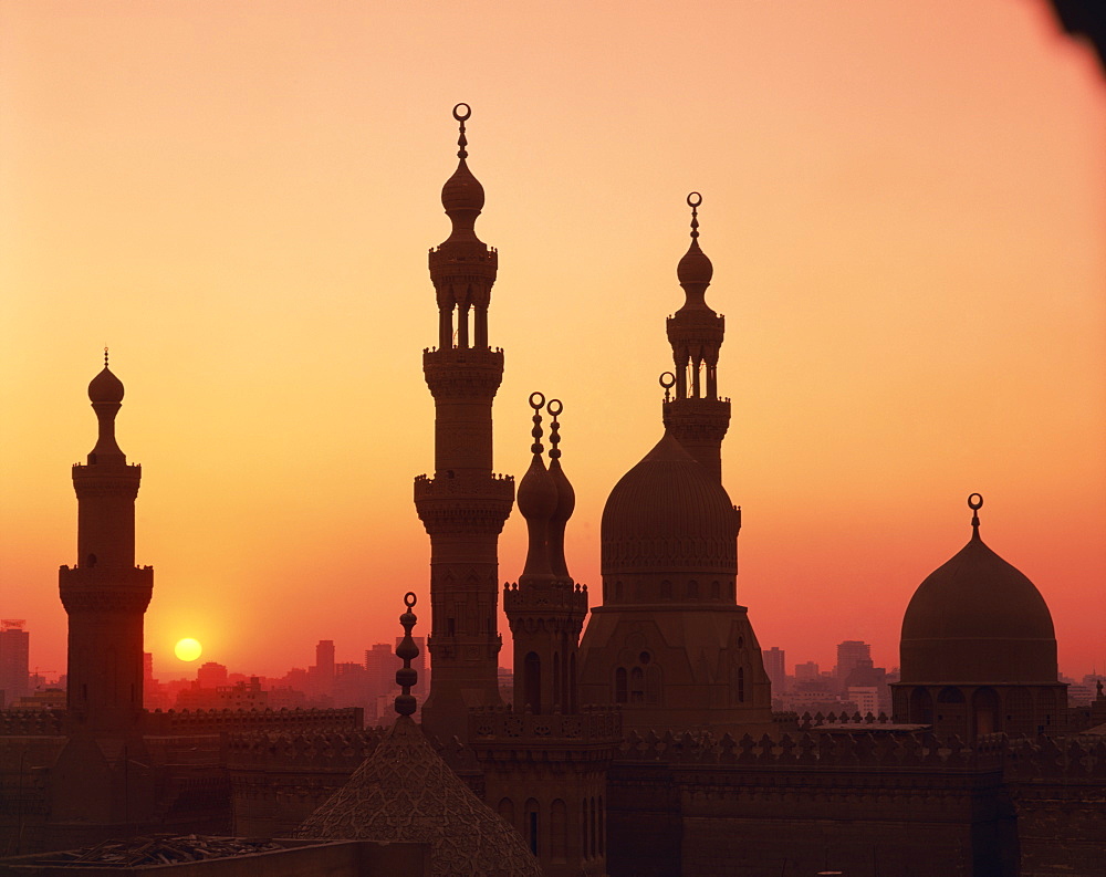 Domes and minarets silhouetted at sunset, Cairo, Egypt, North Africa, Africa