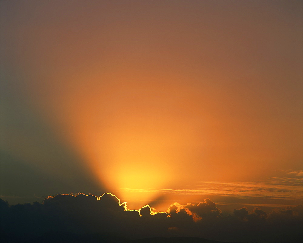 Rays of light bursting out of dark clouds