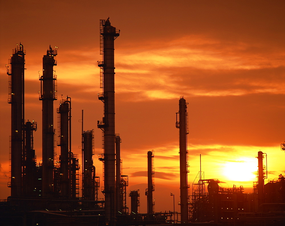 A petro-chemical plant in South Wales silhouetted against the sunset, Wales, United Kingdom, Europe