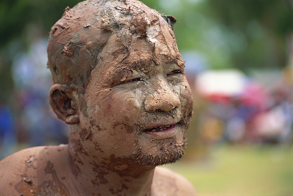 Portrait of a Worship man with a muddy face during Loei Peetakhon festival in Thailand, Southeast Asia, Asia