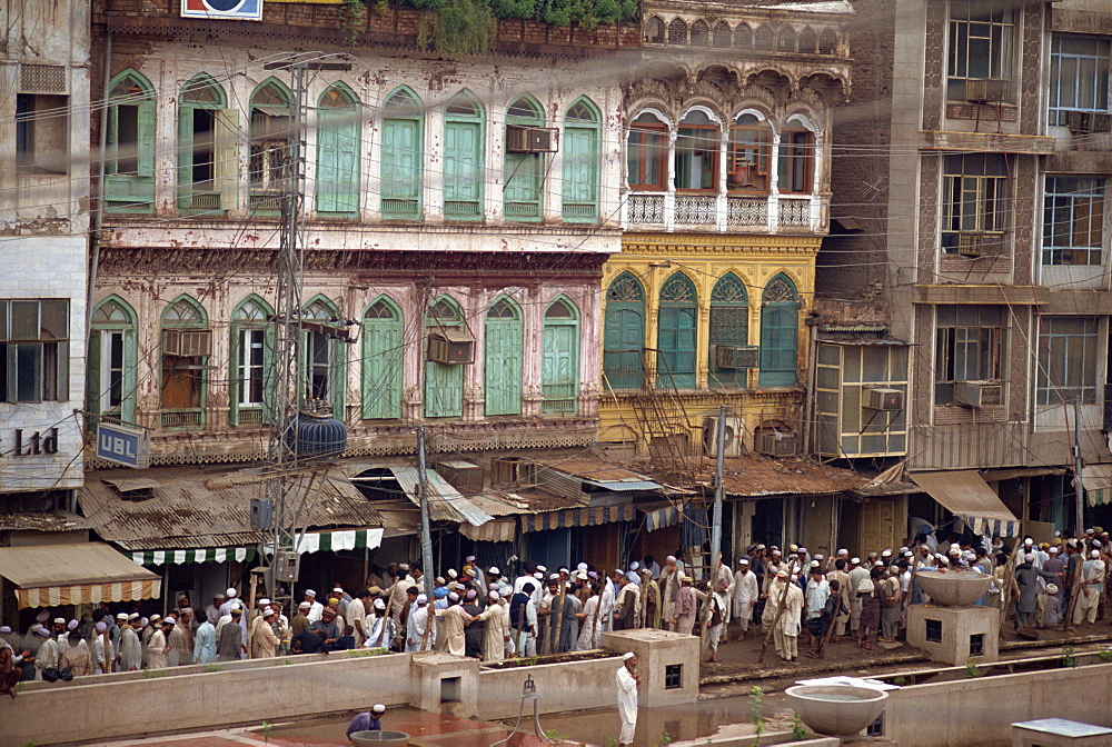 Crowds of men on a street in the old town of Peshawar, Pakistan, Asia