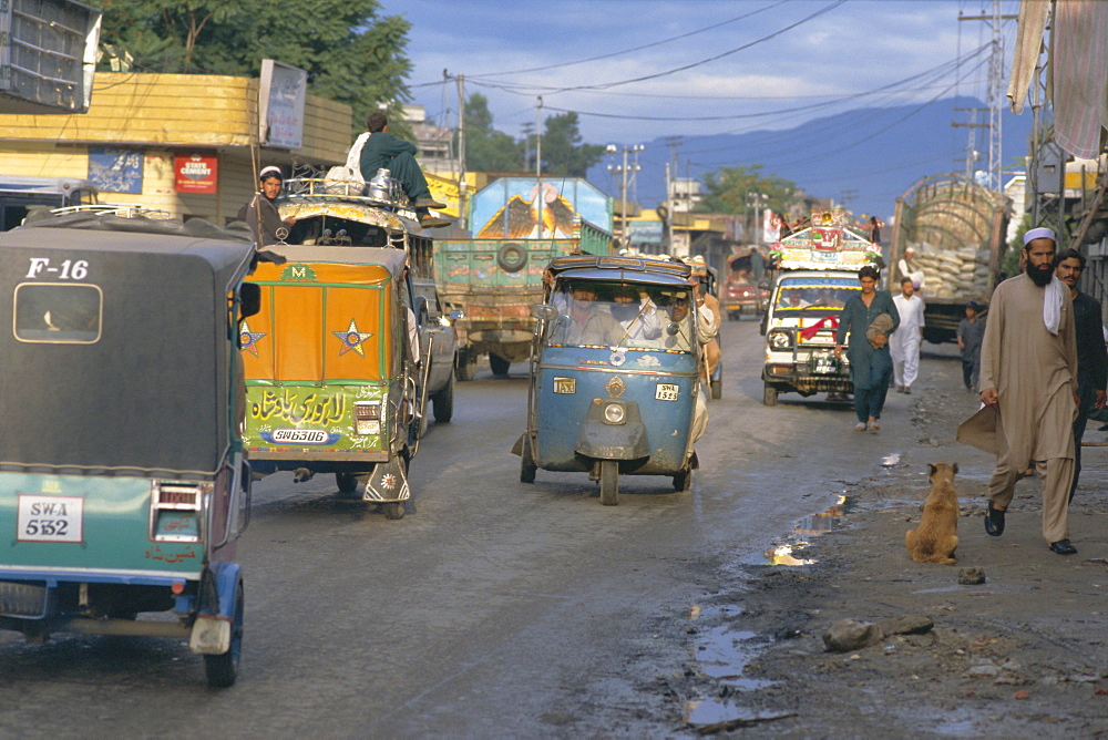 Three wheeled vehicles on main road, Mingora, Swat valley, North West Frontier Province, Pakistan, Asia