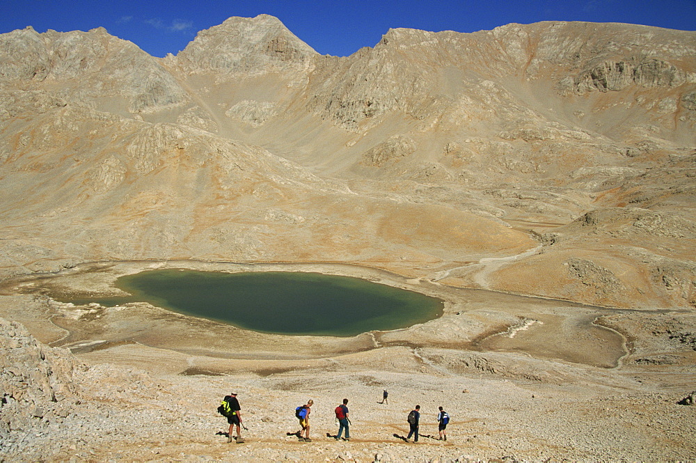 Trekking past lake on Yedigoller Plateau (Seven Lakes), Taurus Mountains, Anatolia, Turkey, Asia Minor, Eurasia