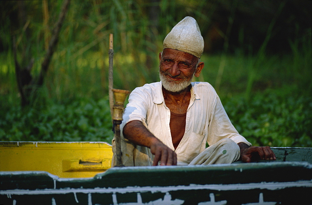 Man sitting in shikara, Dal Lake, Kashmir, India, Asia