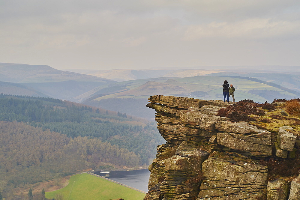 Walkers taking in the view on Hathersage Edge, Ladybower Reservoir below, Peak District National Park, Derbyshire, England, United Kingdom, Europe