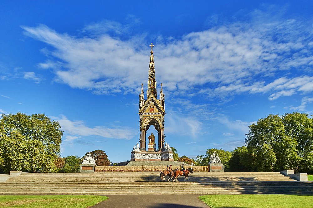 Three heavy horses are ridden past The Albert Memorial, Kensington Gardens, Hyde Park, London, England, United Kingdom, Europe