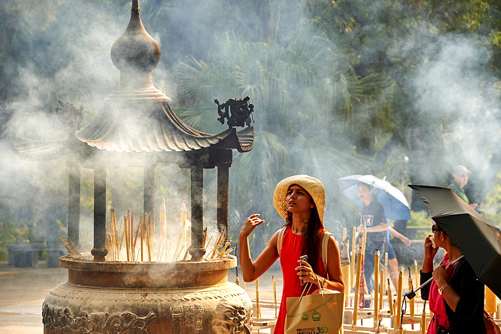 Burning incense at Po Lin Monastery, Ngong Ping, Lantau Island, Hong Kong, China, Asia