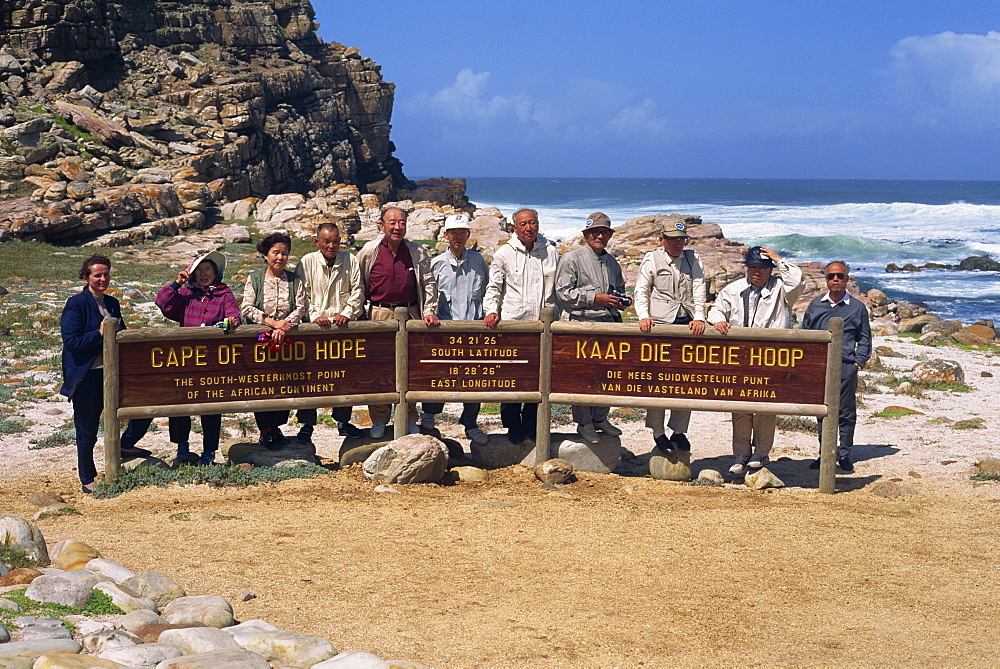 Japanese tourists behind sign at the Cape of Good Hope Nature Reserve, Cape Province, South Africa, Africa