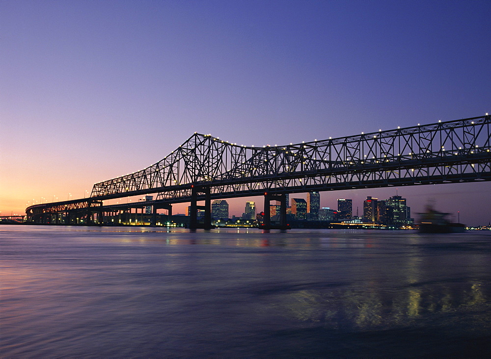 Mississippi River Bridge in the evening and city beyond, New Orleans, Louisiana, United States of America (USA), North America