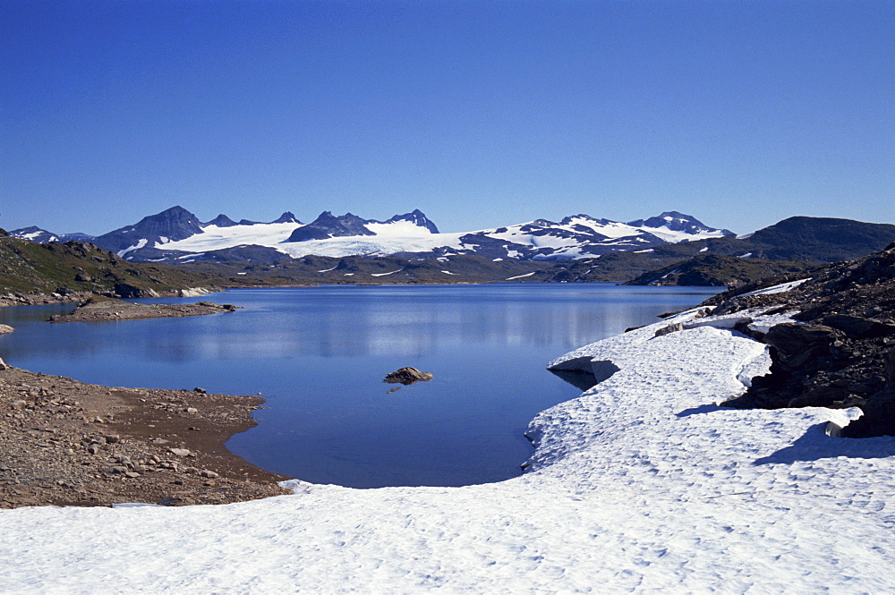 Mountain lake and snowy peaks, Jotunheimen National Park, Norway, Scandinavia, Europe