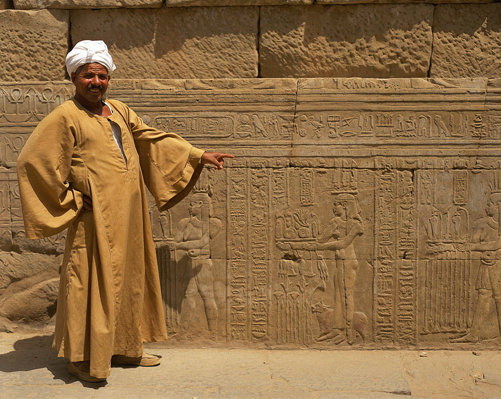 Temple guide with a detail of relief carving including hieroglyphics, Kom Ombo, Egypt, North Africa, Africa