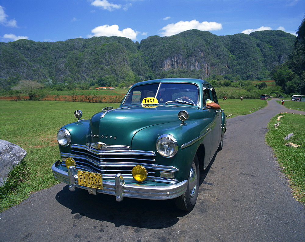 A green Plymouth taxi, a classic pre-Castro American car, in Two Sisters Valley, Vinales, Cuba, West Indies, Caribbean, Central America