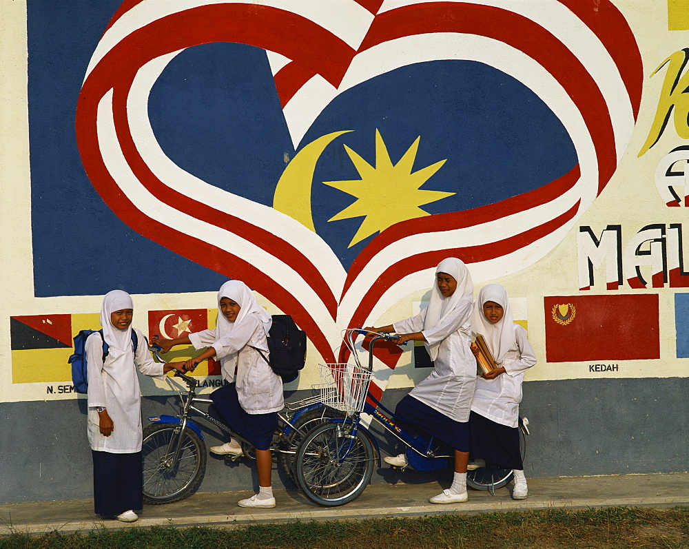 Moslem girls on bicycles in Malaysia, Southeast Asia, Asia