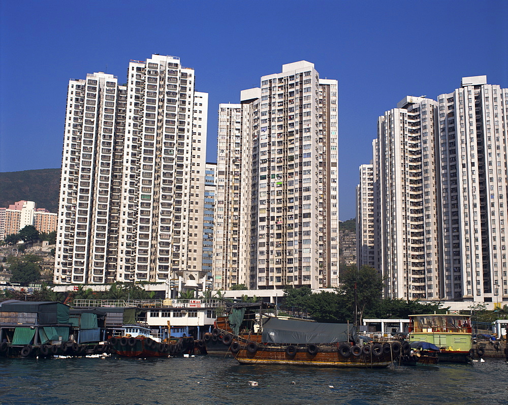 Boats in the harbour and new high rise apartment blocks for people who lived in sampans, at Aberdeen, Hong Kong, China, Asia