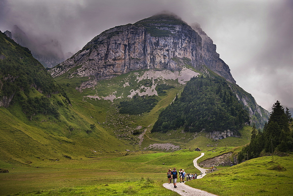 Group of hikers in alpine valley, Engelberg, Switzerland, Europe