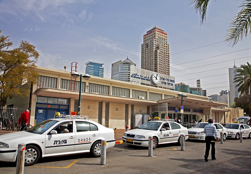 Taxi rank outside the Tel Aviv train station showing the Leonardo City Tower Hotel in distance, Tel Aviv, Israel, Middle East