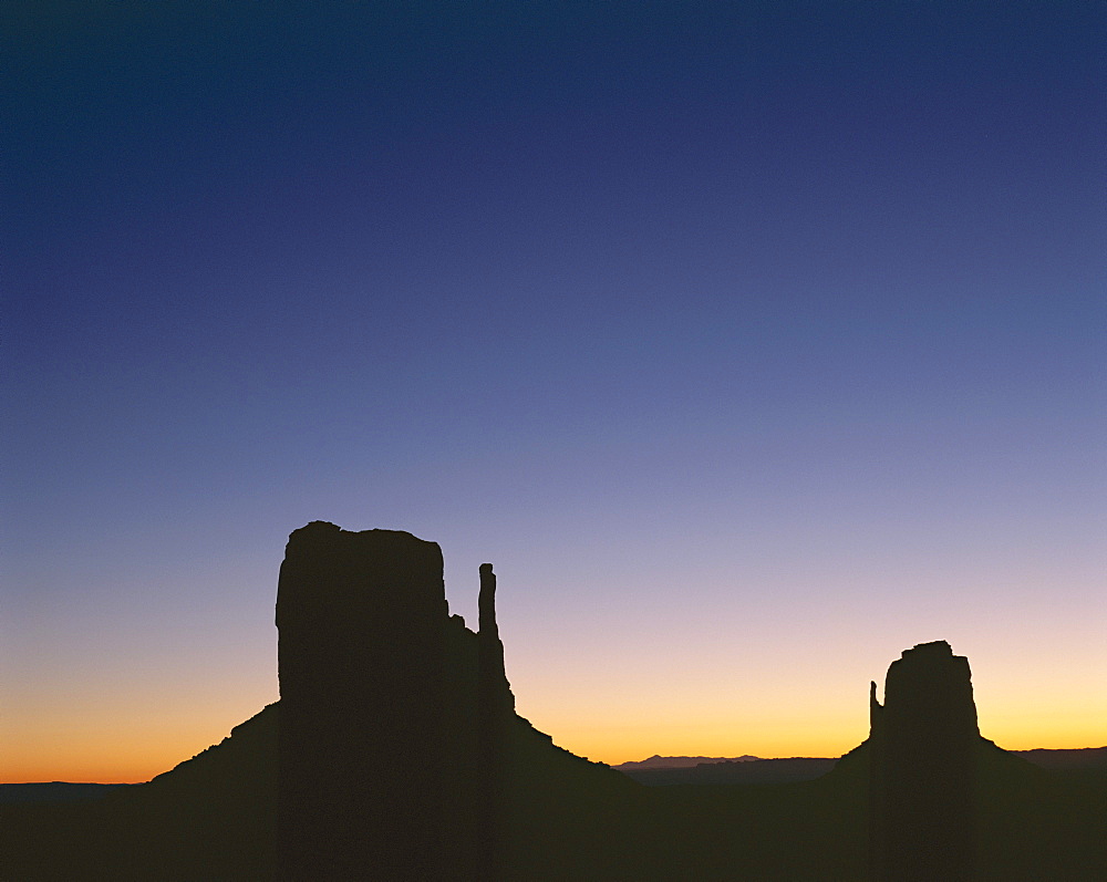 Silhouettes of mitten rock formations at sunset, Utah, United States of America (USA), North America