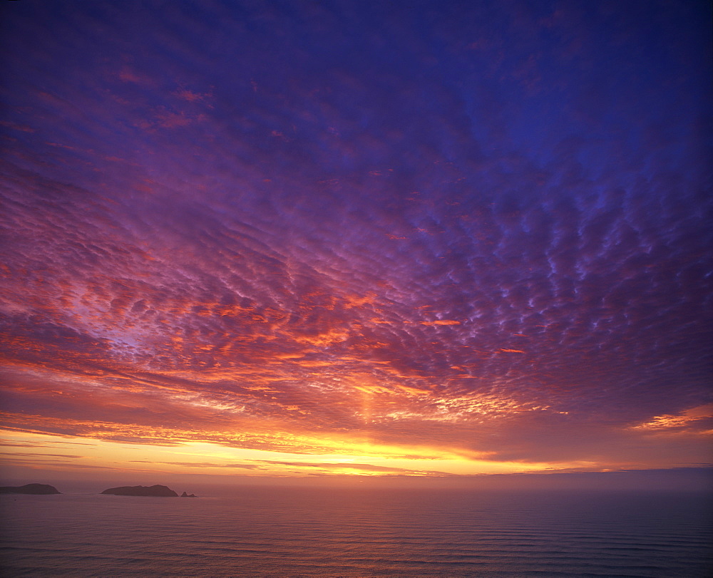 Colourful skies at dusk, over seascape, New Zealand, Pacific